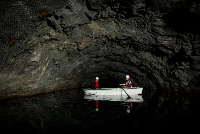 Steven Rose (left), the Cheyenne Mountain Air Force Station deputy director, and the safety chief paddle a boat toward the back of one of Cheyenne Mountain Complex’s underground reservoirs to place a floating device. The underground reservoirs carved from solid rock provide drinking and cooling water, while a lake of diesel fuel sits ready for the six locomotive-sized diesel generators capable of powering a small city. (U.S. Air Force photo/Staff Sgt. Andrew Lee)